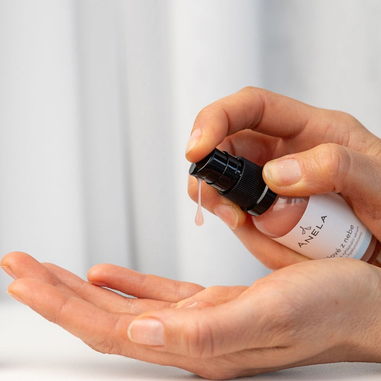 ruka aplikující do dlaně hydratační sérum Růžové z nebe