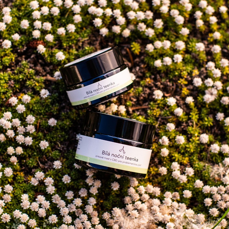 zinkový CBD krém bílá noční teenka, dva kalíšky, položené v jemných květinách