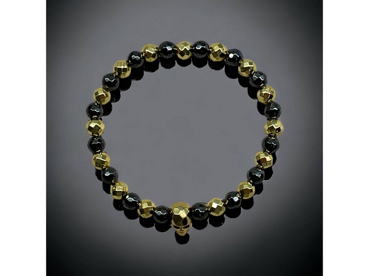 Náramek černo zlatý z broušeného hematitu se zlatou lebkou